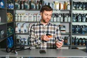 Portrait of a handsome salesman in an auto parts store. The concept of car repair photo