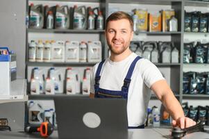 Portrait of a handsome salesman in an auto parts store. The concept of car repair photo