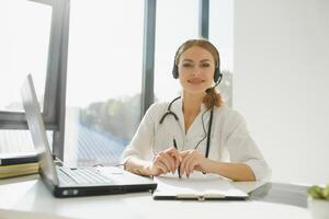 doctor talking with sick person through laptop online system and using mobile digital tablet computer searching patient medical records on the database files document photo