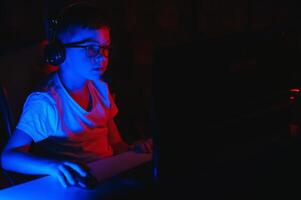 Boy in the headphones is playing a game. photo