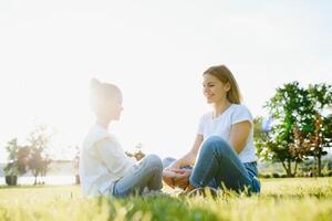 Lifestyle portrait mom and daughter in happines at the outside in the meadow photo