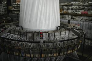 Industrial fabric production line. Weaving looms at a textile factory photo