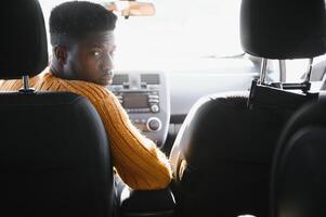 African American driving an electric car. photo