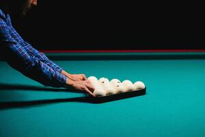 game of billiards the hand of a man with a billiard cue aims at a billiard ball photo