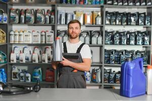 Portrait of a handsome salesman in an auto parts store. The concept of car repair photo