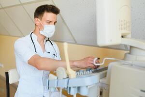 Sonographer using modern ultrasound machine in clinic photo