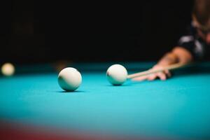 game of billiards the hand of a man with a billiard cue aims at a billiard ball photo