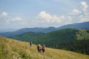 Group of hikers walking on mountain photo