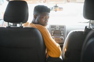 African American driving an electric car. photo