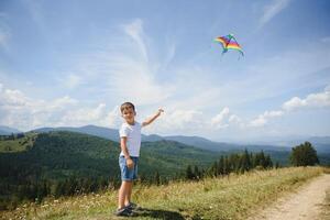 Young boy flies his kite in an open field. a pictorial analogy for aspirations and aiming high photo