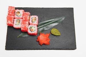 Japanese rolls on black background isolated with reflections photo