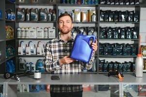 Portrait of a handsome salesman in an auto parts store. The concept of car repair photo