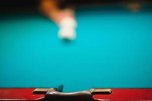 game of billiards the hand of a man with a billiard cue aims at a billiard ball photo