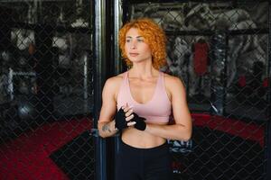 Woman boxer training fighter in gym. Concept mma sport. photo