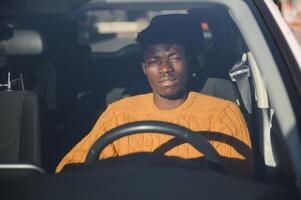 African American driving an electric car. photo