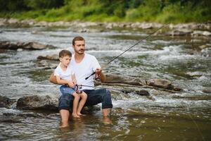 Father and son together fishing photo