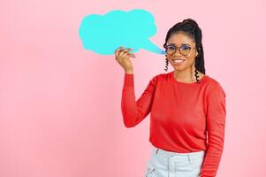 Place For Text. Happy black woman pointing at white advertisement board isolated over pink wall, copyspace. photo