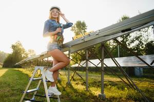 women engineer working on checking equipment at green energy solar power plant checking solar panel and structure with tablet checklist photo