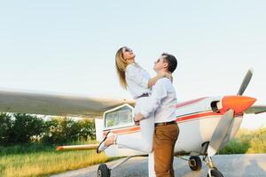 Couple in love hugging near private plane. Selective focus photo