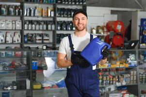 Portrait of a handsome salesman in an auto parts store. The concept of car repair photo