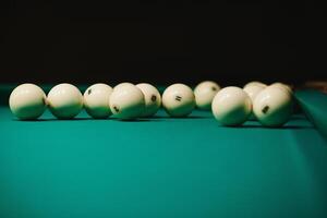 game of billiards the hand of a man with a billiard cue aims at a billiard ball photo