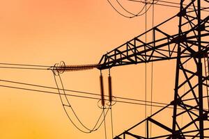 Energy technologies tower shadows. Dark silhouette of electric wire construction. photo