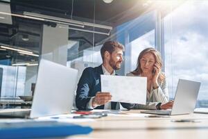 Businessmen talk phone and discussing their business looking at financial charts photo