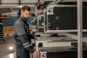 Bearded man aviation mechanic working in hangar photo