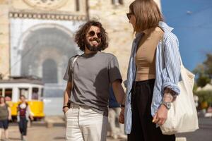 Smiling traveler couple walking on old city street background and holding hands photo