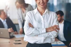 Close up of Portrait of confident business woman looking straight with her team at background photo