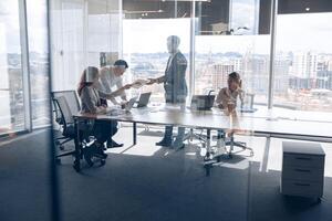 Creative business people working on new project in modern office with panoramic view photo