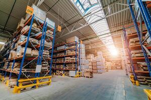 Warehouse storage of a retail goods store. Rows of shelves with boxes photo
