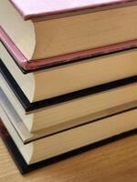 Screen saver with a stack of books. Stack of thick books on the table photo