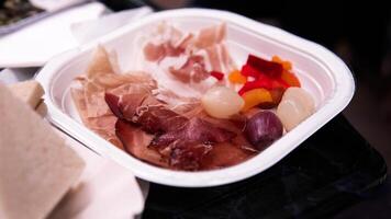 Gourmet Cured Meat and Pickled Vegetables on a Serving Plate photo