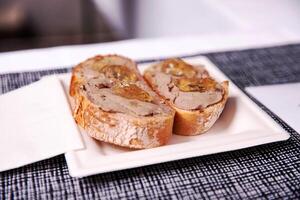 Slices of toasted bread with smooth pate and jelly topping photo