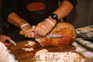 Traditional Artisan Slicing Ham for Gourmet Delicatessen photo