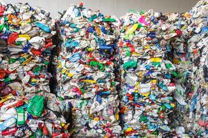 Plastic pressed bales at the modern waste hazardous processing plant. Separate garbage collection. Recycling and storage of waste for further disposal. Business for sorting and processing of waste. photo