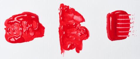 Watercolor brush stroke of red paint on a white isolated background photo