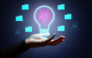 Virtual lamp and woman's hand, concept of searching for a new smart idea photo