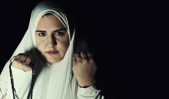 Religious muslim woman in prayer outfit photo