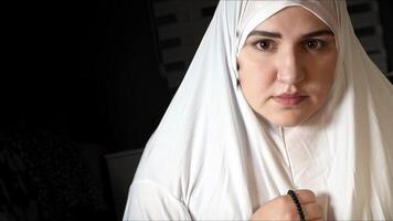 Religious muslim woman in prayer outfit photo