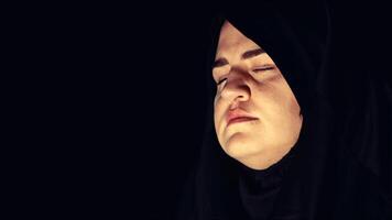 Religious muslim woman in prayer outfit photo