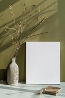 AI generated blank canvas frame template with dry flowers in vase on olive green wall mockup photo