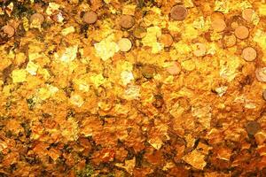 Gold leaf texture or background. Gold leaf and coin on buddha photo