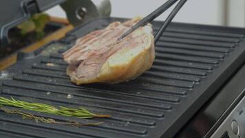 Delicious juicy duck breast is cooked on an electric grill. Roast duck meat on an electric fryer. video