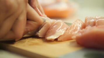 cutting chicken fillet on a chopping board video