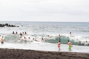 July 26, 2019 Tenerife, Spain, Canary Islands, People on the city beach of Puerto de la Cruz photo