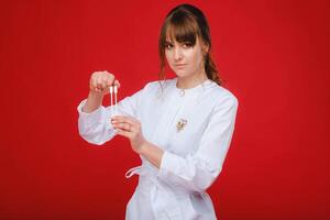 Beautiful girl doctor with a tuning fork stands photo