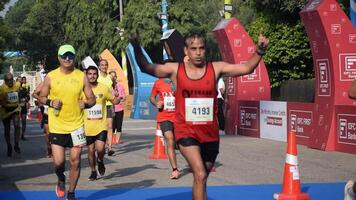 New Delhi, India - October 15 2023 - Vedanta Delhi Half Marathon race after covid in which marathon participants about to cross the finish line, Delhi Half Marathon 2023 video