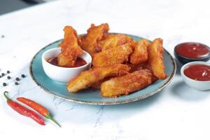 Potatos wedges with tomato sauce served in dish isolated on background side view of fastfood photo